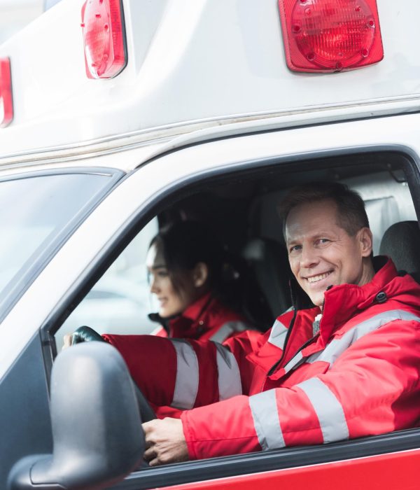 happy-male-and-female-paramedics-sitting-in-ambula-2023-11-27-05-24-39-utc (1)